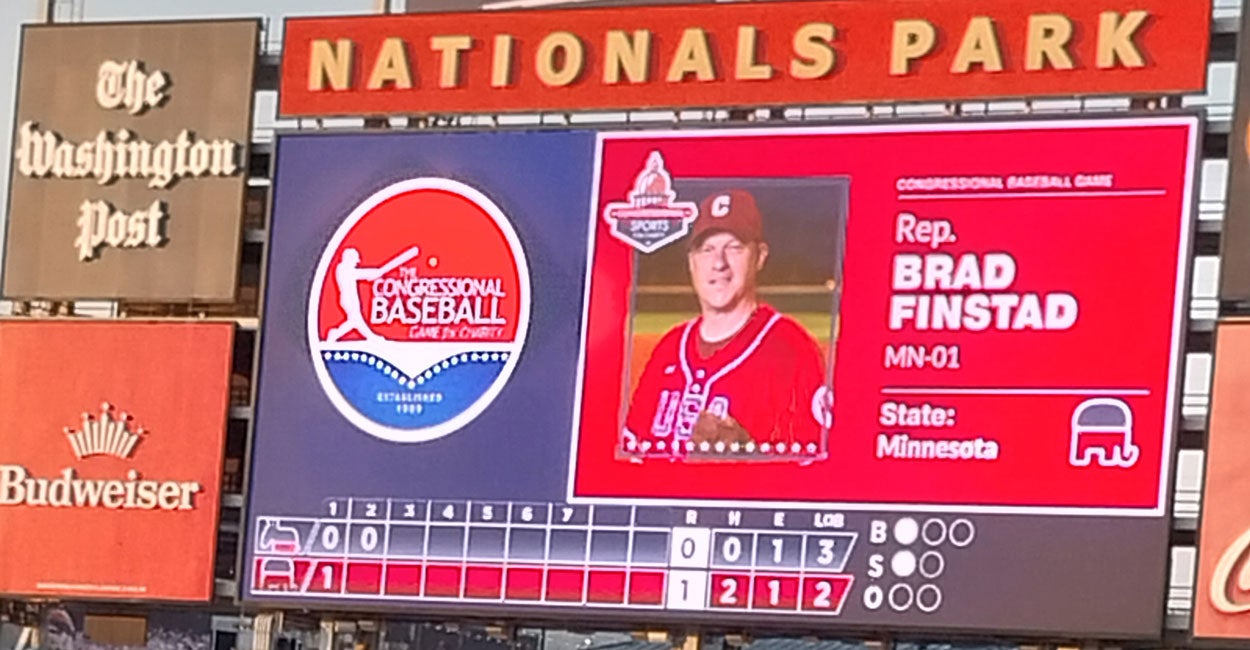 The scoreboard of Washington Nationals Park during the annual Congressional Baseball Game, displaying the image of a batter, Rep. Brad Finstad, R-Minn.