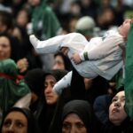 Symbolic Ritual in Iran Sees Women Hold Infants Aloft as Sacrifice