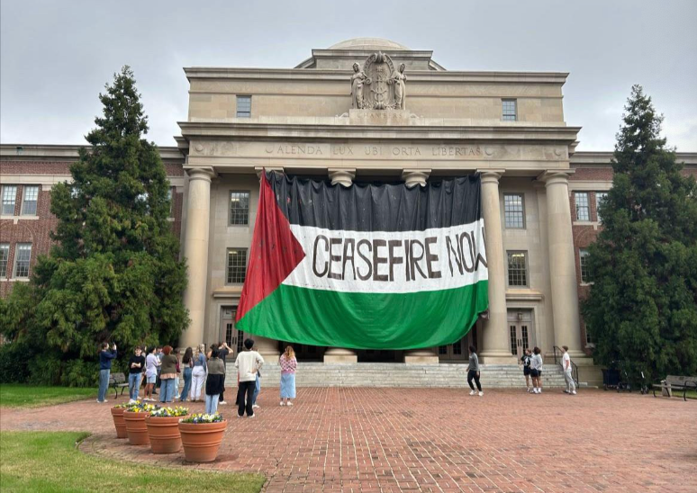 Building at Davidson College with huge Palestinian flag and words "Ceasefire Now" draped across the front.