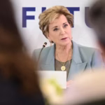 Linda McMahon speaking while seated.