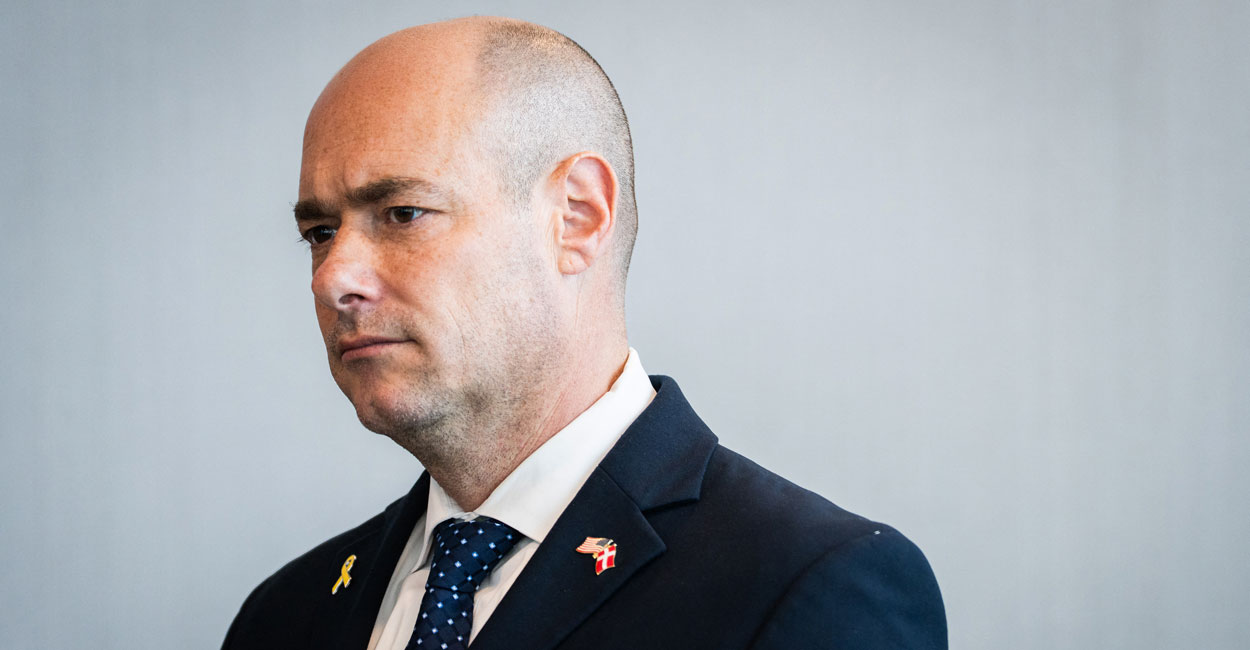 Rep. Greg Landsman stands looking to the side.