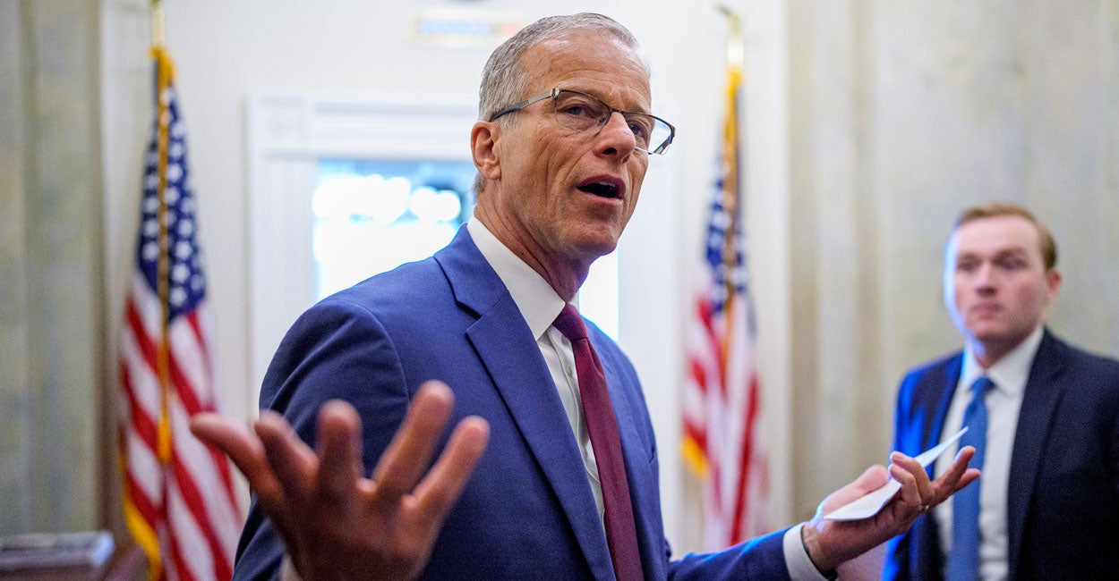 Leader Thune throws up his hands while discussing policy in his capitol office.