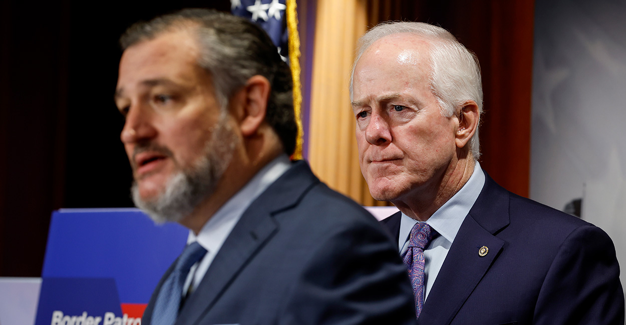 Sen. Cruz and Sen. Cornyn look on.